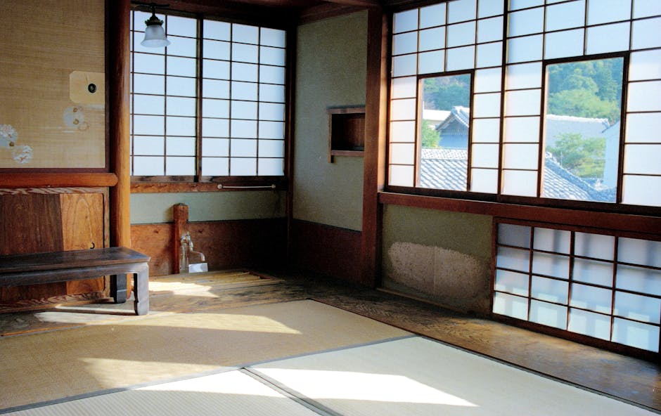 A serene washitsu room with tatami mats and shoji screens in a traditional Japanese setting.