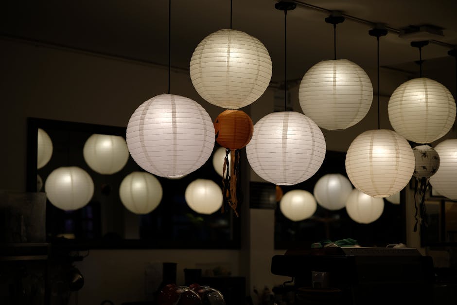 A cozy indoor setting featuring glowing round paper lanterns creating a warm ambiance.